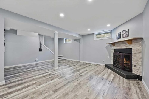 708 101 Avenue Sw, Calgary, AB - Indoor Photo Showing Basement With Fireplace
