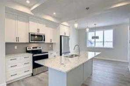63 Lambeau Lane Se, Airdrie, AB - Indoor Photo Showing Kitchen With Stainless Steel Kitchen With Upgraded Kitchen