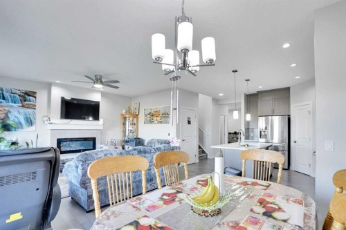 99 Savanna Way Ne, Calgary, AB - Indoor Photo Showing Dining Room With Fireplace