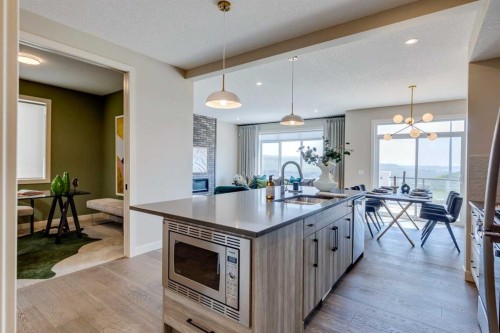 111 Sundown Crescent, Cochrane, AB - Indoor Photo Showing Kitchen With Upgraded Kitchen