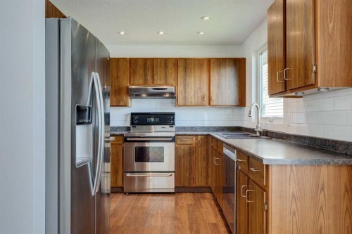 23 Erin Grove Court Se, Calgary, AB - Indoor Photo Showing Kitchen With Double Sink