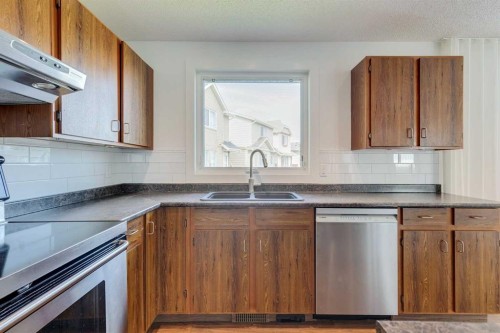 23 Erin Grove Court Se, Calgary, AB - Indoor Photo Showing Kitchen With Double Sink