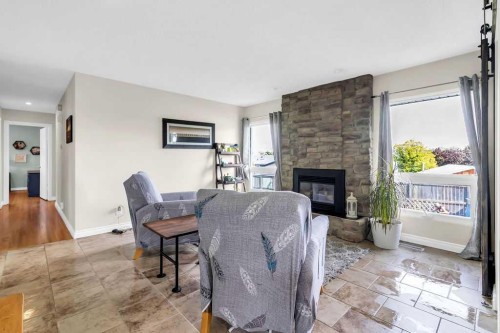 1215 Mapleglade Place Se, Calgary, AB - Indoor Photo Showing Living Room With Fireplace