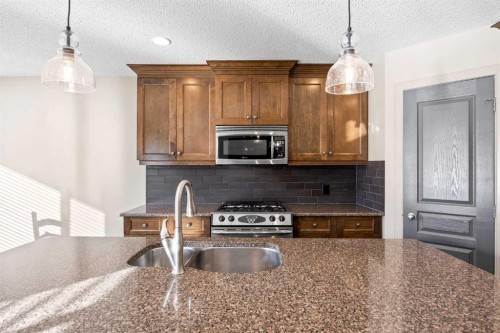 80 Tuscany Summit Terrace Nw, Calgary, AB - Indoor Photo Showing Kitchen With Double Sink With Upgraded Kitchen