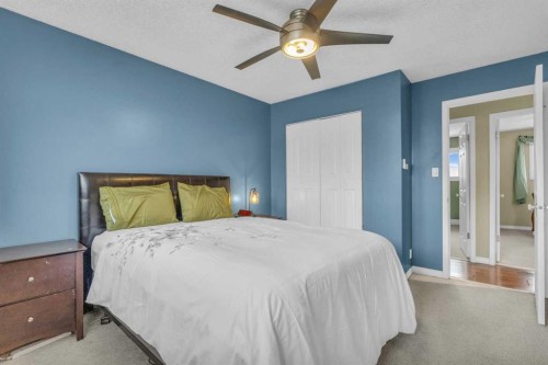 403 Queen Alexandra Way Se, Calgary, AB - Indoor Photo Showing Bedroom