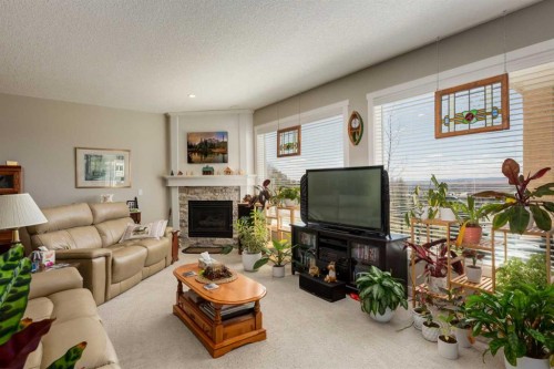 26 Eagleview Way, Cochrane, AB - Indoor Photo Showing Living Room With Fireplace