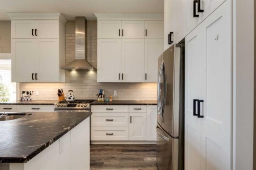 26 Eagleview Way, Cochrane, AB - Indoor Photo Showing Kitchen With Stainless Steel Kitchen With Upgraded Kitchen