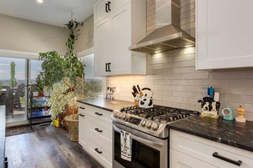 26 Eagleview Way, Cochrane, AB - Indoor Photo Showing Kitchen With Upgraded Kitchen