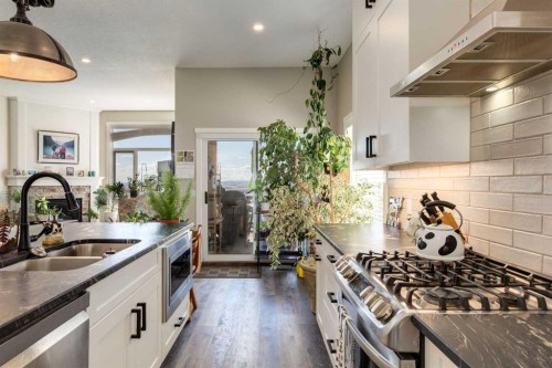 26 Eagleview Way, Cochrane, AB - Indoor Photo Showing Kitchen With Double Sink With Upgraded Kitchen