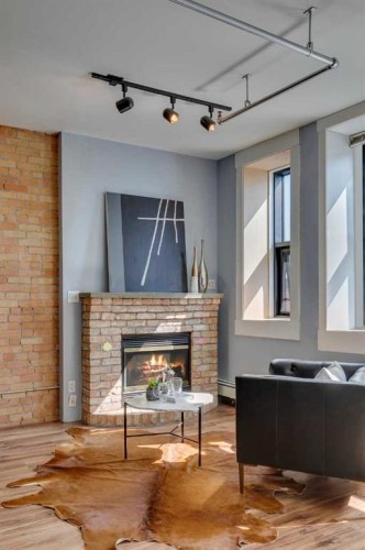 221-220 11 Avenue Se, Calgary, AB - Indoor Photo Showing Living Room With Fireplace