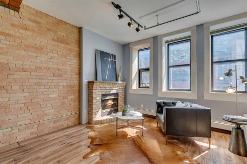 221-220 11 Avenue Se, Calgary, AB - Indoor With Fireplace