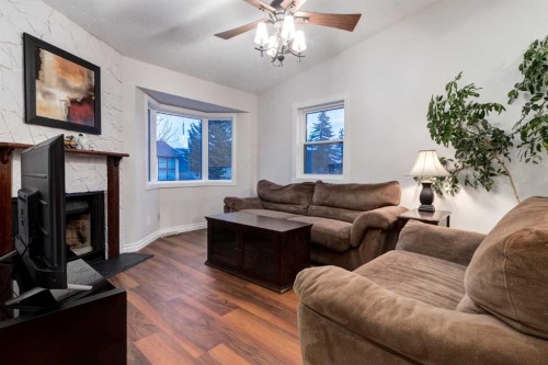 27 Bedfield Close Ne, Calgary, AB - Indoor Photo Showing Living Room With Fireplace