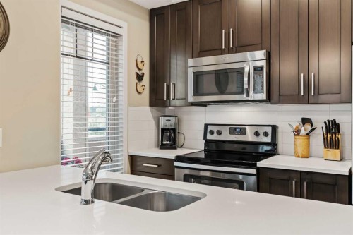 204-10 Mahogany Mews Se, Calgary, AB - Indoor Photo Showing Kitchen With Stainless Steel Kitchen With Double Sink With Upgraded Kitchen