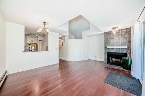 10-305 Village Mews Sw, Calgary, AB - Indoor Photo Showing Living Room With Fireplace