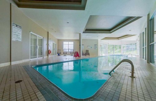 10-305 Village Mews Sw, Calgary, AB - Indoor Photo Showing Other Room With In Ground Pool