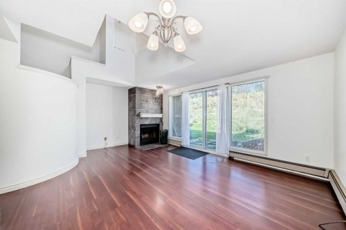 10-305 Village Mews Sw, Calgary, AB - Indoor Photo Showing Living Room With Fireplace