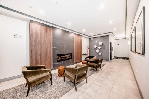210-8355 19 Avenue Sw, Calgary, AB - Indoor Photo Showing Other Room With Fireplace
