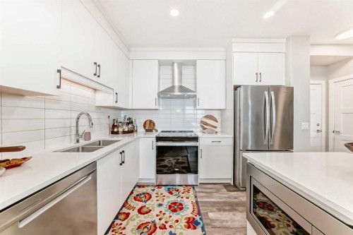 210-8355 19 Avenue Sw, Calgary, AB - Indoor Photo Showing Kitchen With Double Sink With Upgraded Kitchen