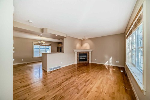 42 Ypres Green Sw, Calgary, AB - Indoor Photo Showing Living Room With Fireplace