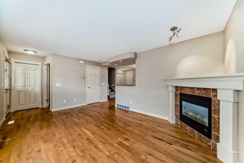 42 Ypres Green Sw, Calgary, AB - Indoor Photo Showing Living Room With Fireplace