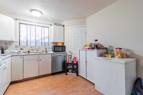 143 Castlegrove Road Ne, Calgary, AB - Indoor Photo Showing Kitchen With Double Sink