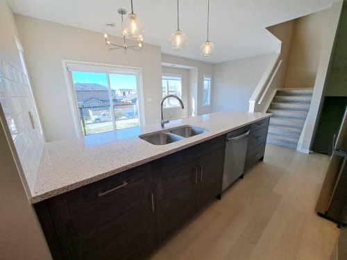 1411-250 Fireside View, Cochrane, AB - Indoor Photo Showing Kitchen With Double Sink