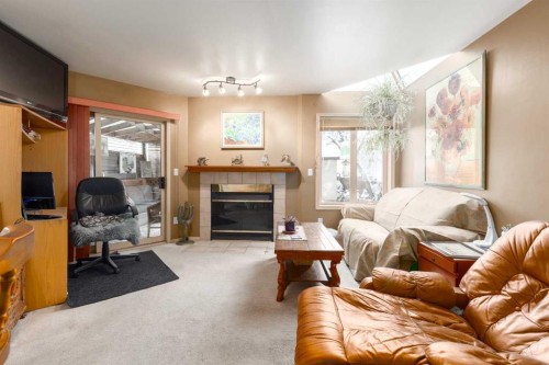 2219 Westmount Road Nw, Calgary, AB - Indoor Photo Showing Living Room With Fireplace