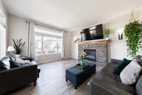 178 Prairie Springs Crescent Sw, Airdrie, AB - Indoor Photo Showing Living Room With Fireplace
