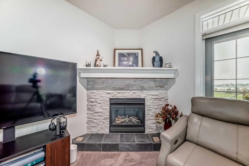 211-1005A Westmount Drive, Strathmore, AB - Indoor Photo Showing Living Room With Fireplace