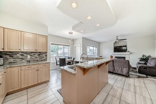 70 Martha'S Meadow Close Ne, Calgary, AB - Indoor Photo Showing Kitchen With Fireplace With Double Sink