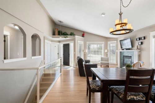 341 Sunset Place, Okotoks, AB - Indoor Photo Showing Dining Room With Fireplace