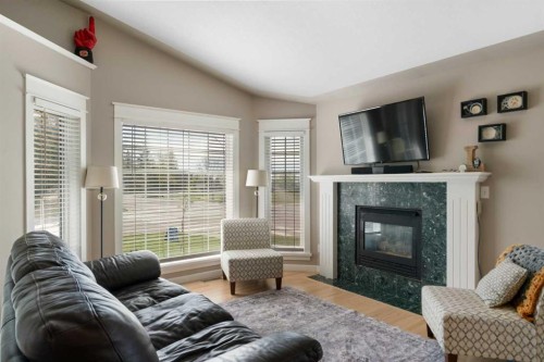 341 Sunset Place, Okotoks, AB - Indoor Photo Showing Living Room With Fireplace