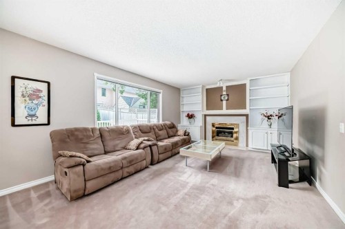 1405 Shawnee Road Sw, Calgary, AB - Indoor Photo Showing Living Room With Fireplace