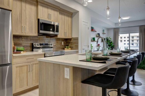 409-245 Edith Place Nw, Calgary, AB - Indoor Photo Showing Kitchen With Upgraded Kitchen