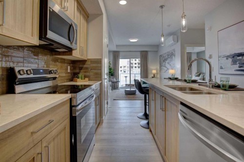 409-245 Edith Place Nw, Calgary, AB - Indoor Photo Showing Kitchen With Double Sink With Upgraded Kitchen