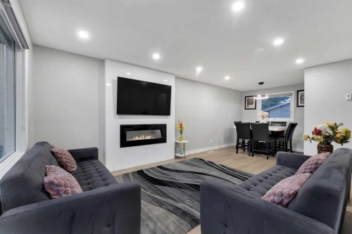 251 Rundlecairn Road Ne, Calgary, AB - Indoor Photo Showing Other Room With Fireplace