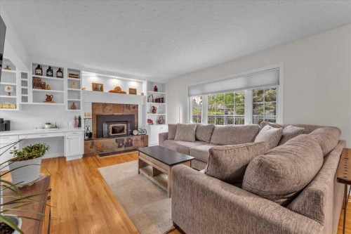 85 Warwick Drive Sw, Calgary, AB - Indoor Photo Showing Living Room With Fireplace