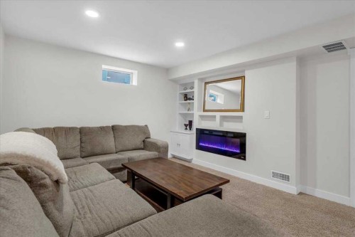 85 Warwick Drive Sw, Calgary, AB - Indoor Photo Showing Living Room With Fireplace