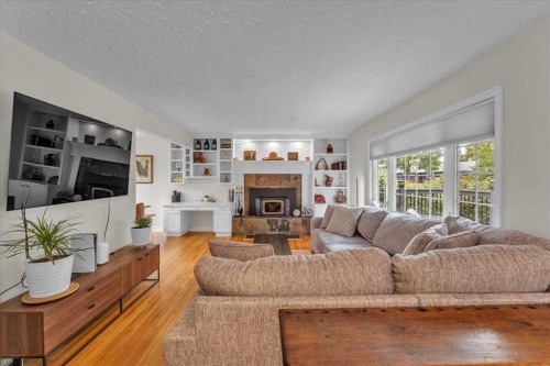 85 Warwick Drive Sw, Calgary, AB - Indoor Photo Showing Living Room With Fireplace