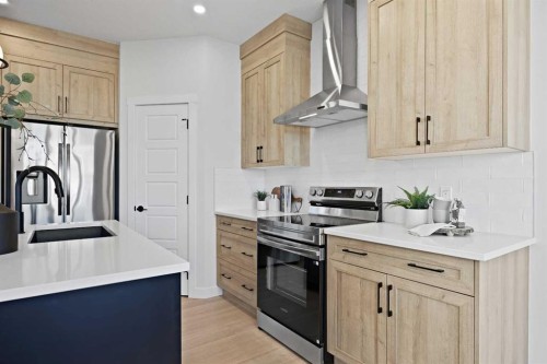 64 Fireside Common, Cochrane, AB - Indoor Photo Showing Kitchen With Upgraded Kitchen