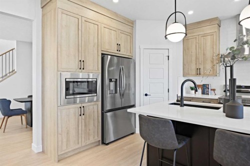 64 Fireside Common, Cochrane, AB - Indoor Photo Showing Kitchen With Upgraded Kitchen