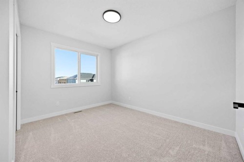 64 Fireside Common, Cochrane, AB - Indoor Photo Showing Other Room