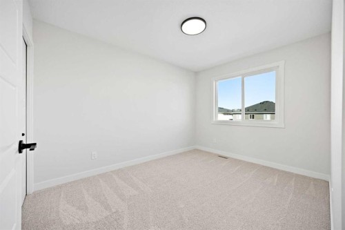 64 Fireside Common, Cochrane, AB - Indoor Photo Showing Other Room