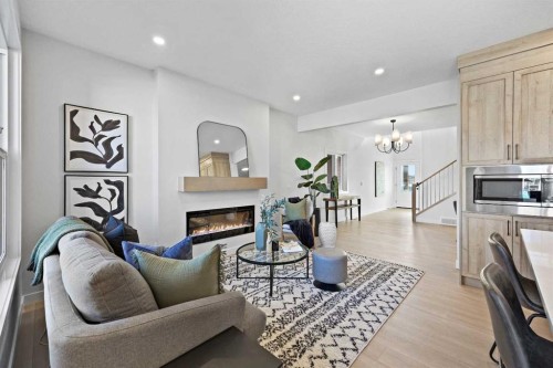 64 Fireside Common, Cochrane, AB - Indoor Photo Showing Living Room With Fireplace