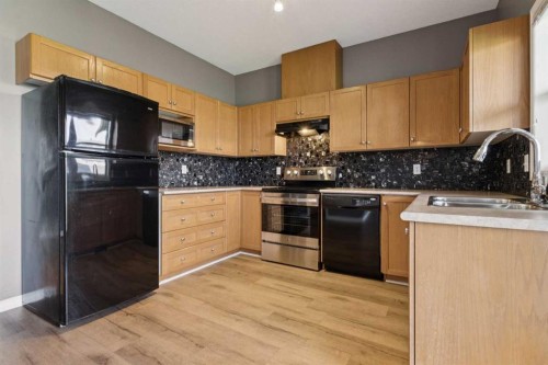 104-2001 Luxstone Boulevard Sw, Airdrie, AB - Indoor Photo Showing Kitchen With Double Sink