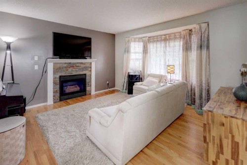 134 Hidden Way Nw, Calgary, AB - Indoor Photo Showing Living Room With Fireplace