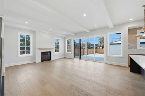 703 35 Street Nw, Calgary, AB - Indoor Photo Showing Living Room With Fireplace