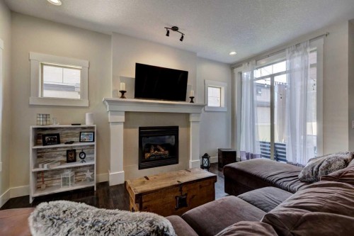 152 Mike Ralph Way Sw, Calgary, AB - Indoor Photo Showing Living Room With Fireplace