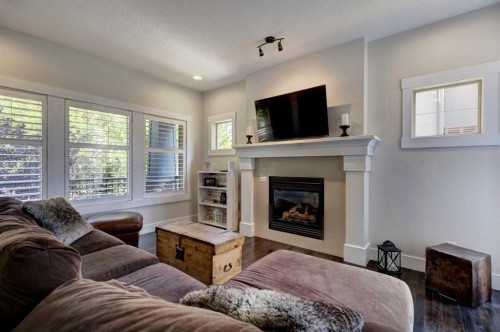 152 Mike Ralph Way Sw, Calgary, AB - Indoor Photo Showing Living Room With Fireplace