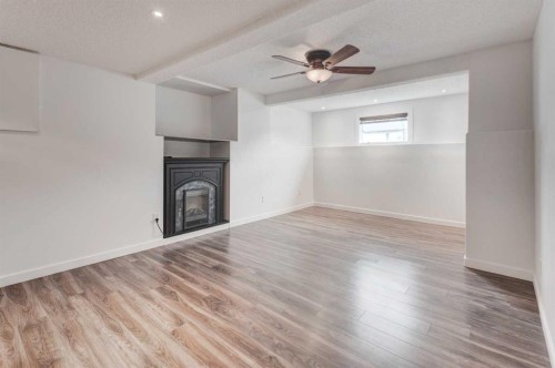 405 2 Avenue Nw, Diamond Valley, AB - Indoor With Fireplace